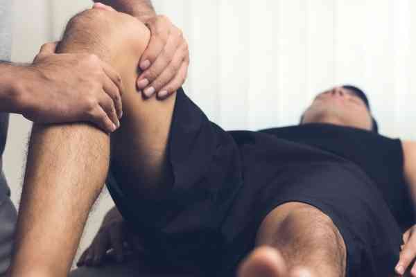 Revamp Sports Massage Therapist treating athlete with deep tissue massage